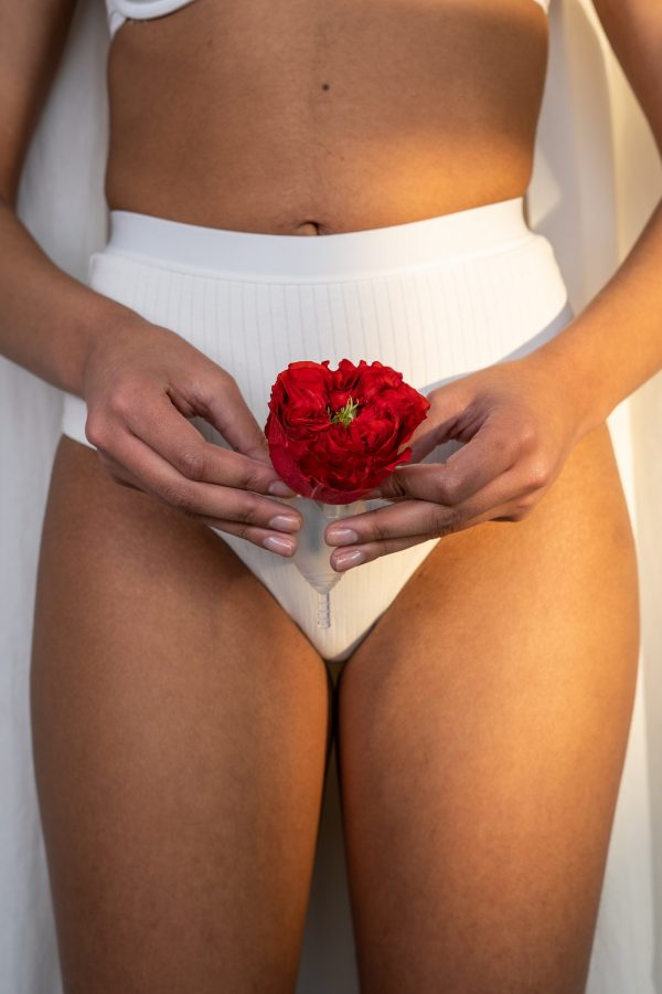 woman-in-white-underwear-holding-red-rose-and-menstrual-cup-3737820