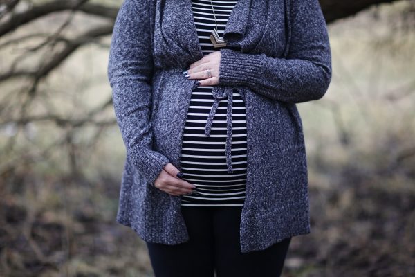 woman-pregnant-in-black-and-white-striped-shirt-standing-952597