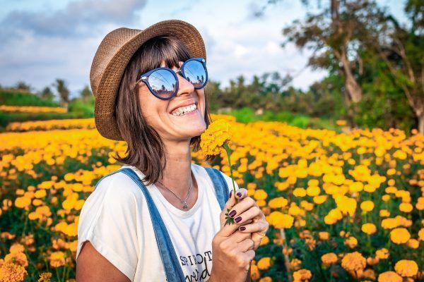 woman-holding-yellow-petaled-flowers-1547094
